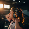 © Margarita Ratatosk - Caucasian woman gamer in headset with microphone concentrated on playing online video game. Esport tournament event with female player competing.