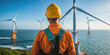 © Александр Марченко - Engineer worker looking at offshore wind farm turbines