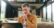 © AzeemudDeen25/peopleimages.com - Laptop, research and stress with man on sofa in living room of home for vacation planning. Computer, travel itinerary and worry with mature person in apartment for online booking mistake or problem