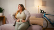 © RZ Images - Overweight woman holds stomach bending forward in sudden pain
