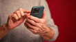 © RZ Images - Closeup, man holding mobile phone text message, scrolling, watching video selective focus on hands