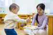 © leungchopan - Mother playing with her baby in indoor playhouse