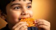 © TAIFUR - a young boy with a delighted expression enjoys a vibrant piece of jalebi a classic indian sweet savoring its sugary and syrupy goodness with joy