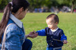 © leungchopan - Happy baby playing with mother at park