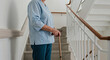 © Tamaras Pictures 4U - Elderly woman standing at the top of the stairs with cane