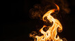 © ProArt Studios - Intense, golden-orange flames flicker and dance against a deep black background, creating a striking visual contrast with ample copy space.