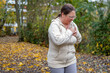 © kittyfly - plus size woman stops during autumn run holding chest, heart discomfort, jogging, running challenge, health awareness, exercise caution, unexpected pause outdoors, outdoor fitness, active lifestyle