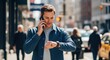 © MST - Man on phone checking time while walking downtown