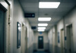 © ADPShapla - Blurred institutional corridor with fluorescent lights and doors
