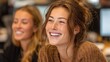 © SaroStock - Two asian female colleagues share a lighthearted moment, laughing together in a modern office setting during the daytime