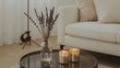 © Lasvu - A vase with lavender and two lit candles on a black tray in a cozy living room with a beige sofa.