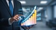 © ArtStock - Businessperson holding tablet showing growing bar graph, rising arrow. Digital graphic overlays demonstrate cost reduction. Tech solutions for efficient cost saving. Business improvement concept.