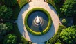 © Viktor - Aerial view of circular garden fountain with water jets spraying upwards. Green trimmed hedges surround pool, with paved walkways, trees nearby. Design elegant, modern, creating peaceful outdoor