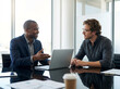 © Andrew505 - Business collaboration and professional consultation with two diverse male colleagues discussing a project on a laptop.