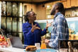 © DC Studio - Upset African American couple fighting at home in their kitchen. Black woman looks offended and yelling at man, symbolizing emotional stress and difficulty of disagreement and argument.