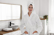 © New Africa - Beautiful woman wearing bathrobe and towel on hair indoors