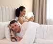 © New Africa - Offended couple after quarrel ignoring each other in bed at home, selective focus