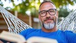 © Design Depot - Relaxing in a hammock with a book on a sunny afternoon