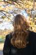 © Yevhen - Portrait of a young woman in sunny autumn park. Back view