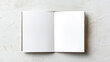 © siraphol - Blank open notebook mockup with two white pages textured surface showing minimal calm composition