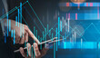 © ImageFlow - Businessman holding tablet with glowing financial data graphics overlay, futuristic style, on dark blue background, concept of digital investments