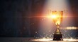 © SOEM - A golden trophy cup with a glowing light inside, standing on a wooden table with a dark background.
