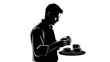 © dayat - A silhouette of a man preparing or serving coffee cups on a tray.