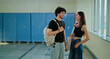 © Raushan_films - Indian happy young adult gen z girl meet boy pupil guy spend break time at college campus place. Smart male man lady female wear bag talk share new plan gossip enjoy day hallway