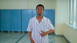 © Raushan_films - African young adult gen z male man hold laptop look camera standing indoor good campus area. Happy teen age boy pupil staring cam do casual pose ready for new exam day time inside college place