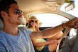 © ReeseArcurs/peopleimages.com - Travel, sunglasses and couple driving on road trip for vacation, romance and anniversary for date. Car, vehicle and people with adventure for bonding, relax and holiday for tourist transportation
