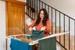© Martí Rosselló - Woman drying clothes on indoor laundry rack