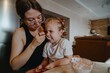 © looking2thesky - A cheerful 4-year-old girl prepares for breakfast in a bright morning living room. Authentic childhood moment of family routine and natural morning energy