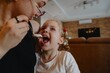 © looking2thesky - A cheerful 4-year-old girl prepares for breakfast in a bright morning living room. Authentic childhood moment of family routine and natural morning energy