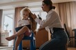 © looking2thesky - A mother gently brushes her 4-year-old daughter's long beautiful hair. Authentic moment of family hair care, bonding and natural parenting love