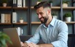© lan - Businessman using laptop computer in office. Happy middle aged man, entrepreneur, small business owner working online. High quality