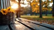 © Fahri - A wicker basket filled with sunflowers sits on a wooden park bench, with autumn leaves scattered around. The image is bathed in warm sunlight.