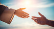 © Cliff - Close-up of Jesus' hand reaching out for salvation to a man's hand, isolated on a sky background and with sunlight. Miracle of saving the life of Jesus Christ, the Son of God, salvation of the soul