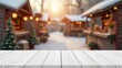 © rahwik - empty white wooden table outdoors with blurred christmas stall background and space for design