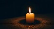 © antuanetto - Remembrance candle flame illuminating deep darkness for memorial, hope, and solemn contemplation concept, especially for International Holocaust Remembrance Day