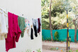 © Tenacity_1987 - after laundry activity that is drying clothes in sunlight at the backyard of house.