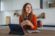 © Miljan Živković - Happy woman using smart phone working from home office