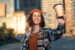 © SHOTPRIME STUDIO - woman coffee smile urban candid beanie sunlight takeaway. Portrait of a young woman holding a takeaway cup at golden hour glow, authenticity and mindful living with emotional storytelling, casual