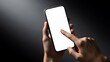 © bagas - Close-up of a person's hands interacting with a modern mobile device featuring a blank white screen for mockup purposes, isolated on a dark background