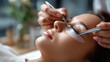 © Kateryna - Eyelash extension procedure master tweezers fake lashes beautiful eyes faceless professional and client defocused treatment background lash application scene beauty