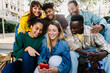 © Xavier Lorenzo - Multiracial young people having fun watching social media content on phone. Technology lifestyle and social media concept