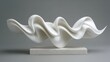 © mila103 - A white sculpture of a wave is on a white pedestal. The sculpture is made of white marble and has a smooth, flowing shape. The wave appears to be in motion, as if it is about to crash onto the shore