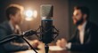 © Margarita Ratatosk - Studio microphone setup for interview or podcast with two men in background. Professional sound recording for broadcast journalism concept.