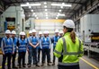 © Meow Creations - Female Manager Leading Safety Briefing for Industrial Workers in a Modern Factory Setting