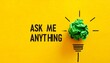 © Aura - “ASK ME ANYTHING” on yellow with green paper bulb—evoking curiosity, creativity, and the bold choreography of questions, ideas, and open dialogue.