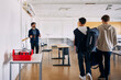 © Maskot - Smiling male teacher talking with students entering in classroom at high school